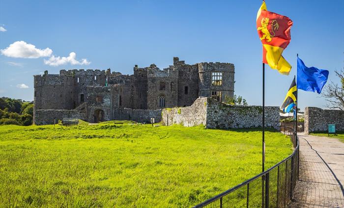 Carew Castle at another angle and showing the range of flags flying.